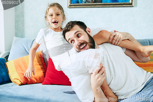 Image of Father and his six years kid girl at home