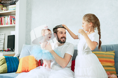 Image of The happy father and his baby daughters at home