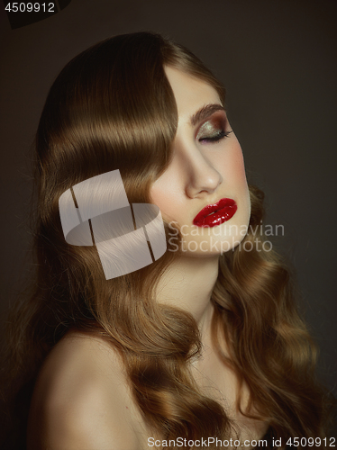 Image of Close-up indoor portrait of lovely girl with colorful hair. Studio shot of graceful young woman with long haircut