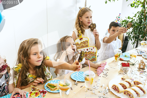 Image of Girl birthday decorations. table setting with cakes, drinks and party gadgets.