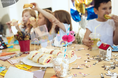 Image of Girl birthday decorations. table setting with cakes, drinks and party gadgets.