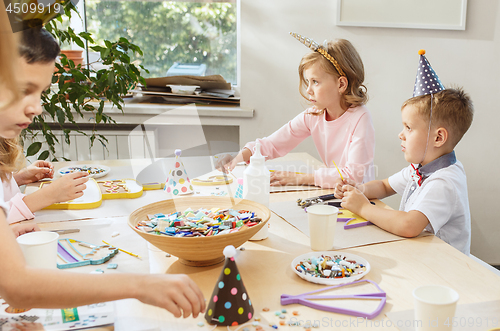 Image of Girl birthday decorations. table setting with cakes, drinks and party gadgets.