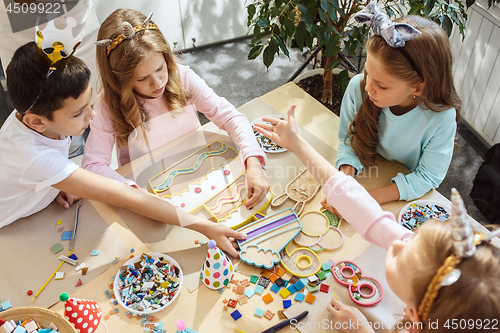 Image of Girl birthday decorations. table setting with cakes, drinks and party gadgets.