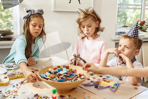 Image of Girl birthday decorations. table setting with cakes, drinks and party gadgets.