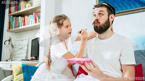 Image of Father and his six years kid girl at home