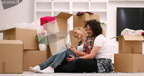 Image of young couple moving  in new house