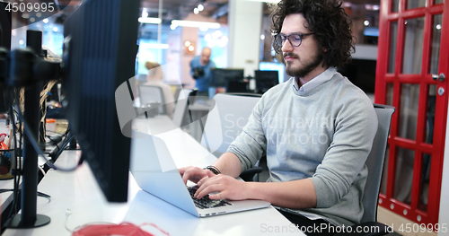 Image of businessman working using a laptop in startup office