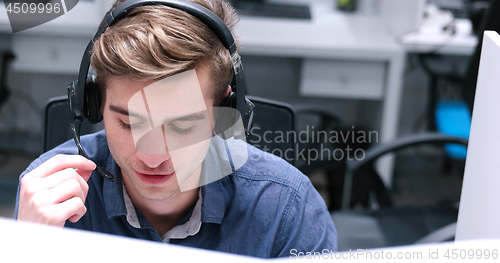 Image of male call centre operator doing his job