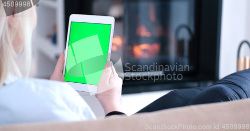 Image of woman on sofa using tablet computer