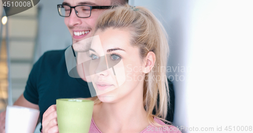 Image of young couple enjoying morning coffee
