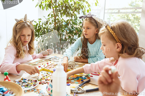 Image of Girl birthday decorations. table setting with cakes, drinks and party gadgets.