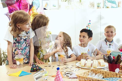 Image of Girl birthday decorations. table setting with cakes, drinks and party gadgets.