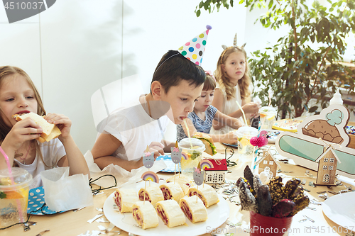 Image of Girl birthday decorations. table setting with cakes, drinks and party gadgets.