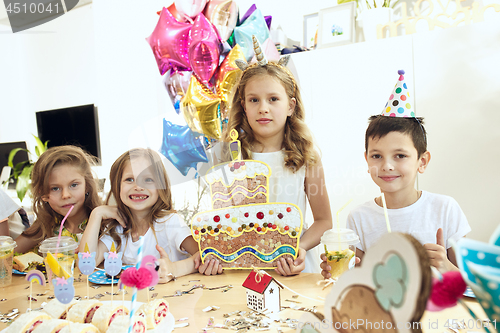 Image of Girl birthday decorations. table setting with cakes, drinks and party gadgets.