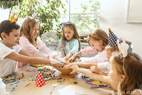 Image of Girl birthday decorations. table setting with cakes, drinks and party gadgets.