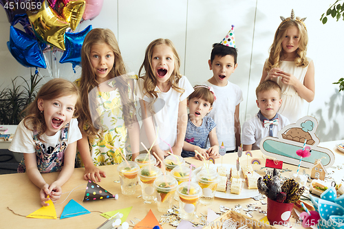 Image of Girl birthday decorations. table setting with cakes, drinks and party gadgets.