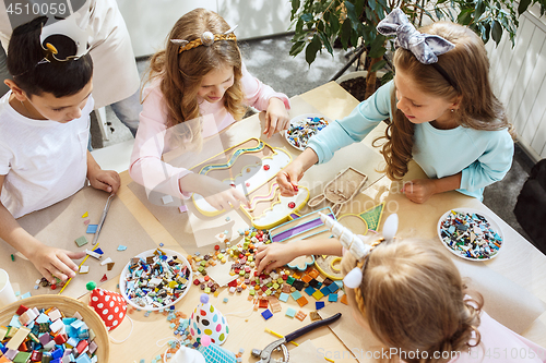 Image of Girl birthday decorations. table setting with cakes, drinks and party gadgets.