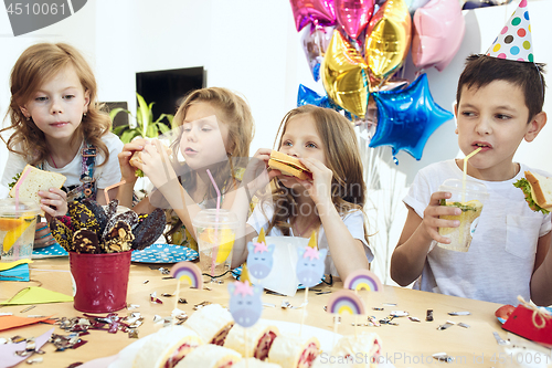 Image of Girl birthday decorations. table setting with cakes, drinks and party gadgets.