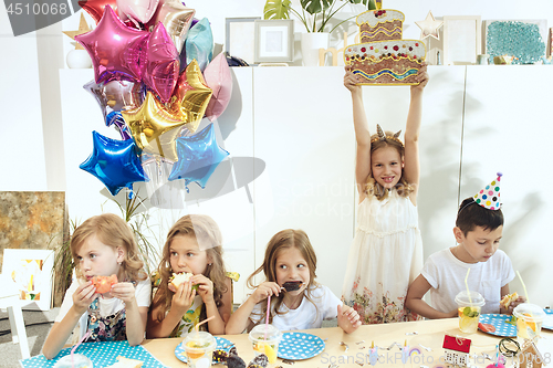 Image of Girl birthday decorations. table setting with cakes, drinks and party gadgets.