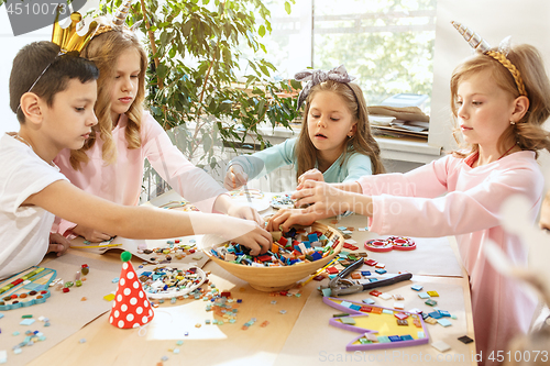 Image of Girl birthday decorations. table setting with cakes, drinks and party gadgets.