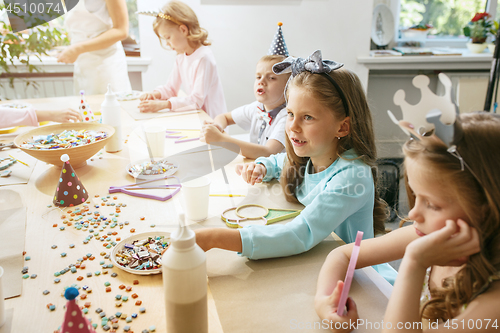 Image of Girl birthday decorations. table setting with cakes, drinks and party gadgets.