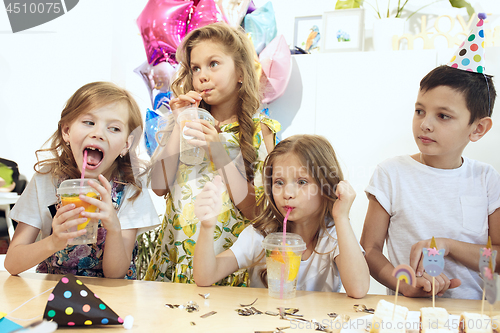 Image of Girl birthday decorations. table setting with cakes, drinks and party gadgets.