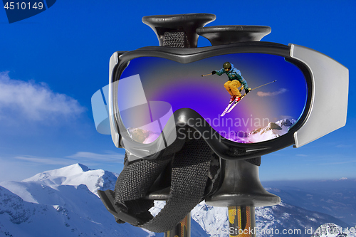 Image of Jumping Skier in the Mountain a reflection in ski goggles