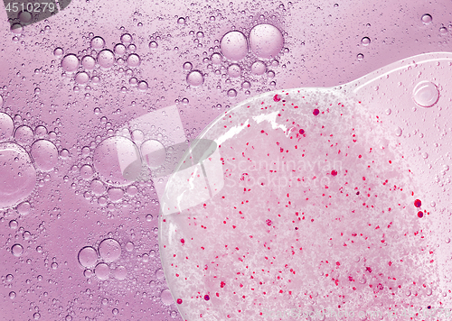 Image of cosmetic liquid with bubbles and scrub gel textures