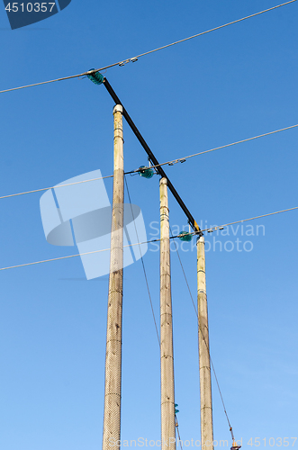 Image of Electricity transmission cables by wooden poles