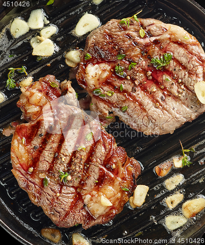 Image of grilled steaks on grilling pan