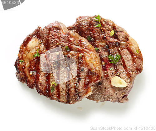 Image of grilled steaks on white background