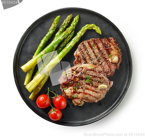 Image of plate of grilled steaks on white background