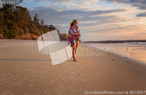 Image of Female relaxed morning walks along the beach