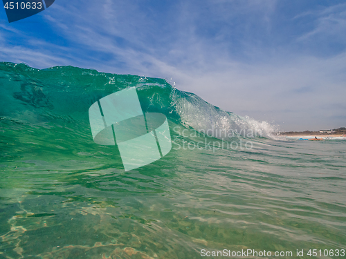 Image of Ocean beach wave curling  onto the shore