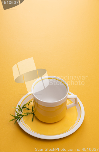 Image of Ceramic teacup on yellow background