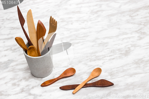 Image of Handcrafted wooden utensils in a concrete cup