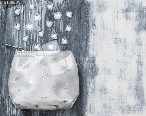 Image of Silver purse and glass beads on artistic background