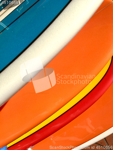 Image of Colourful surfboards lined up in a row