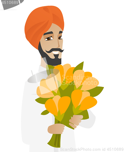 Image of Hindu businessman holding bouquet of flowers.