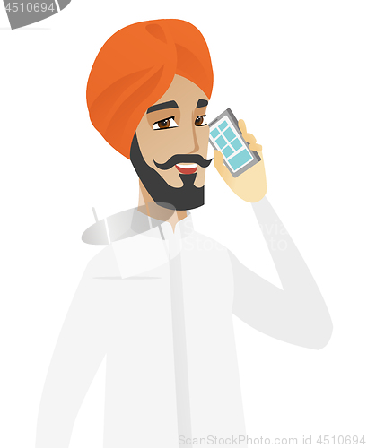 Image of Hindu businessman talking on a mobile phone.