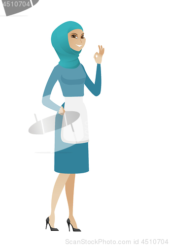 Image of Young muslim cleaner showing ok sign.