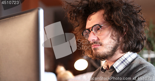 Image of businessman working using a computer in startup office