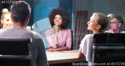 Image of Multiethnic startup business team in night office