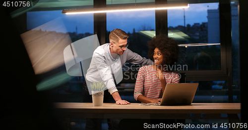 Image of Multiethnic startup business team in night office