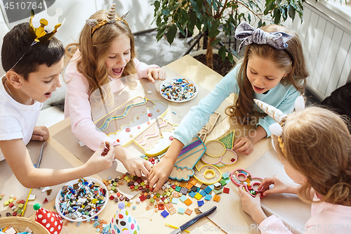 Image of Girl birthday decorations. table setting with cakes, drinks and party gadgets.