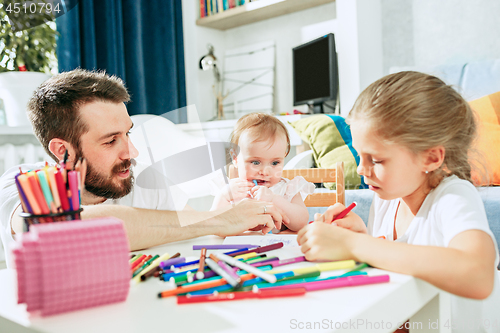 Image of father and his baby daughter at home