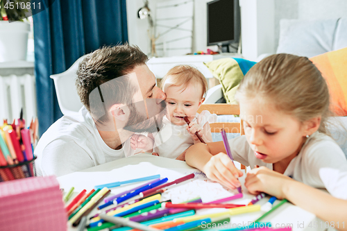 Image of father and his baby daughter at home