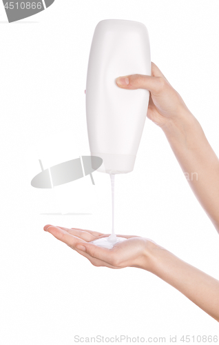 Image of White bottle of shower gel lotion cream in hands