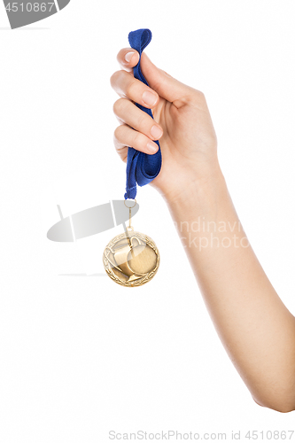 Image of Girl hand raised holding gold medal 