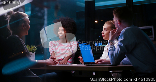 Image of Multiethnic startup business team in night office